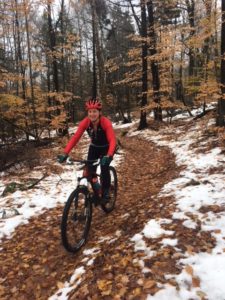 Sky riding a mountain bike at Blueberry Lake in Warren, Vermont